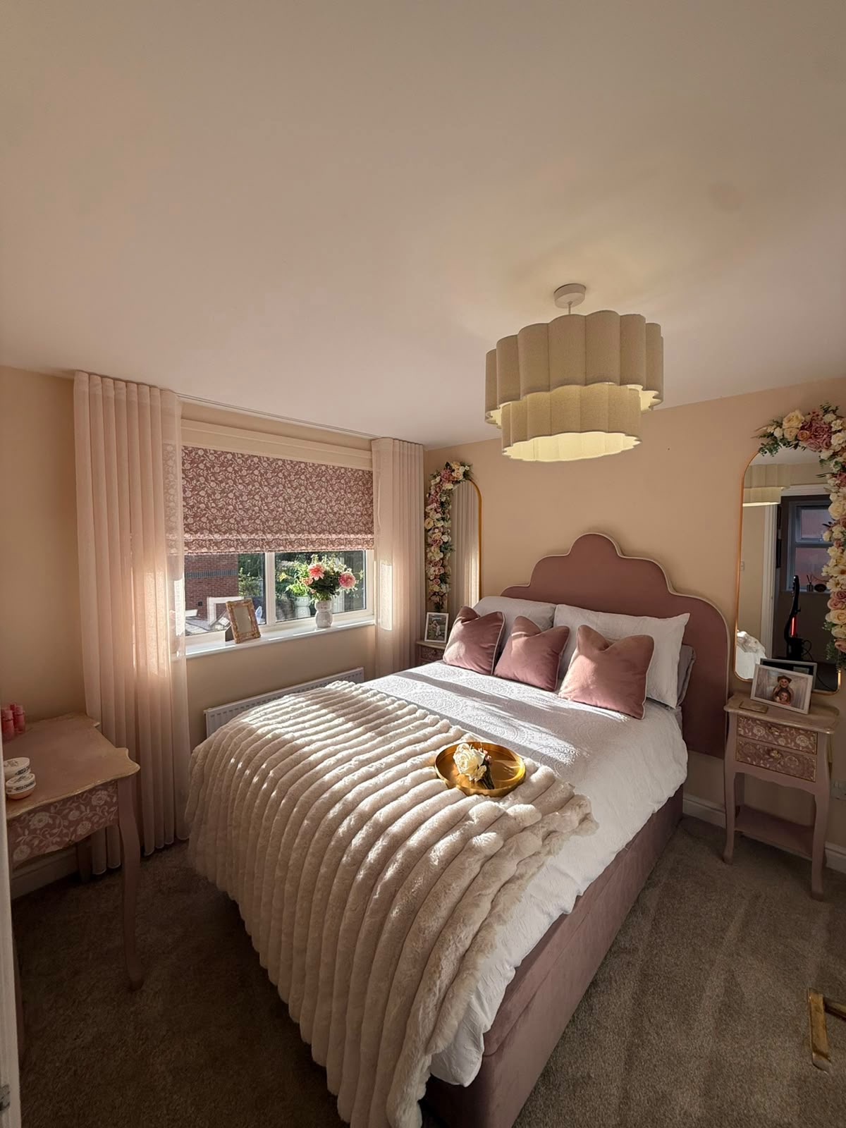 The transformed pink bedroom: soft blush headboard, fluffy throw and floral mirrors