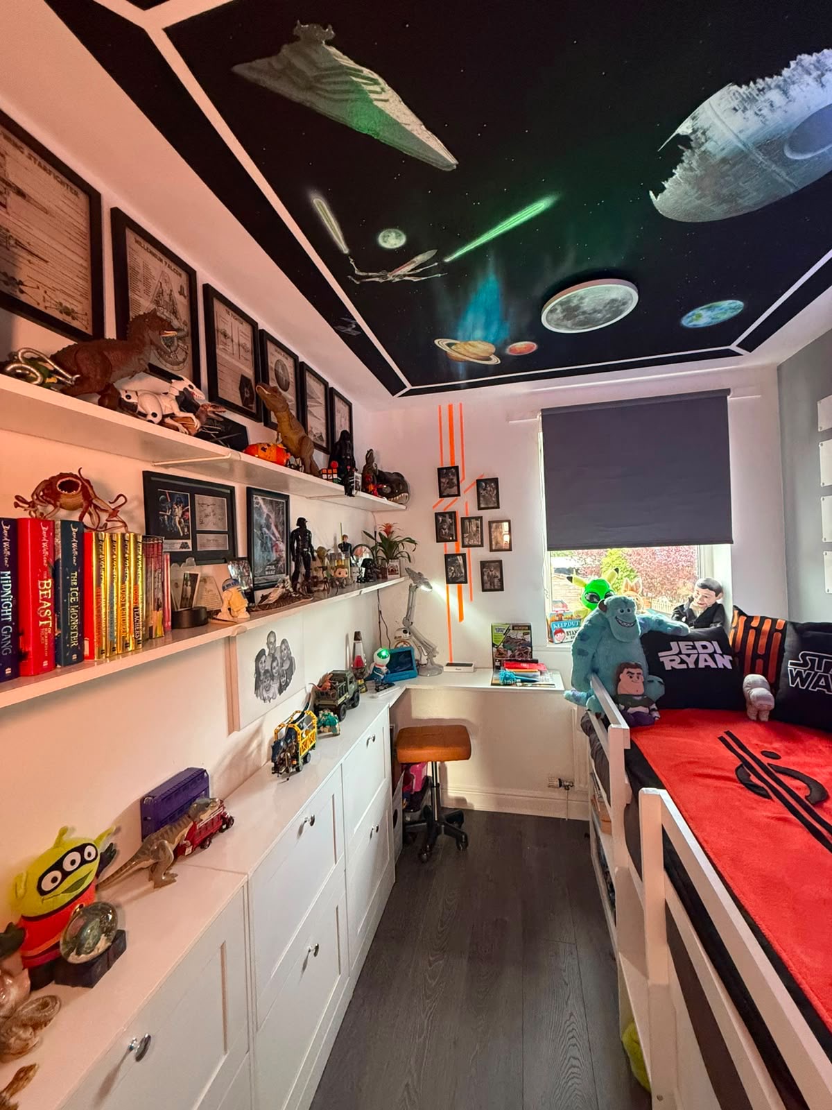 Ryan's transformed Star Wars bedroom: space mural ceiling, shelves of collectibles and a cosy cabin bed